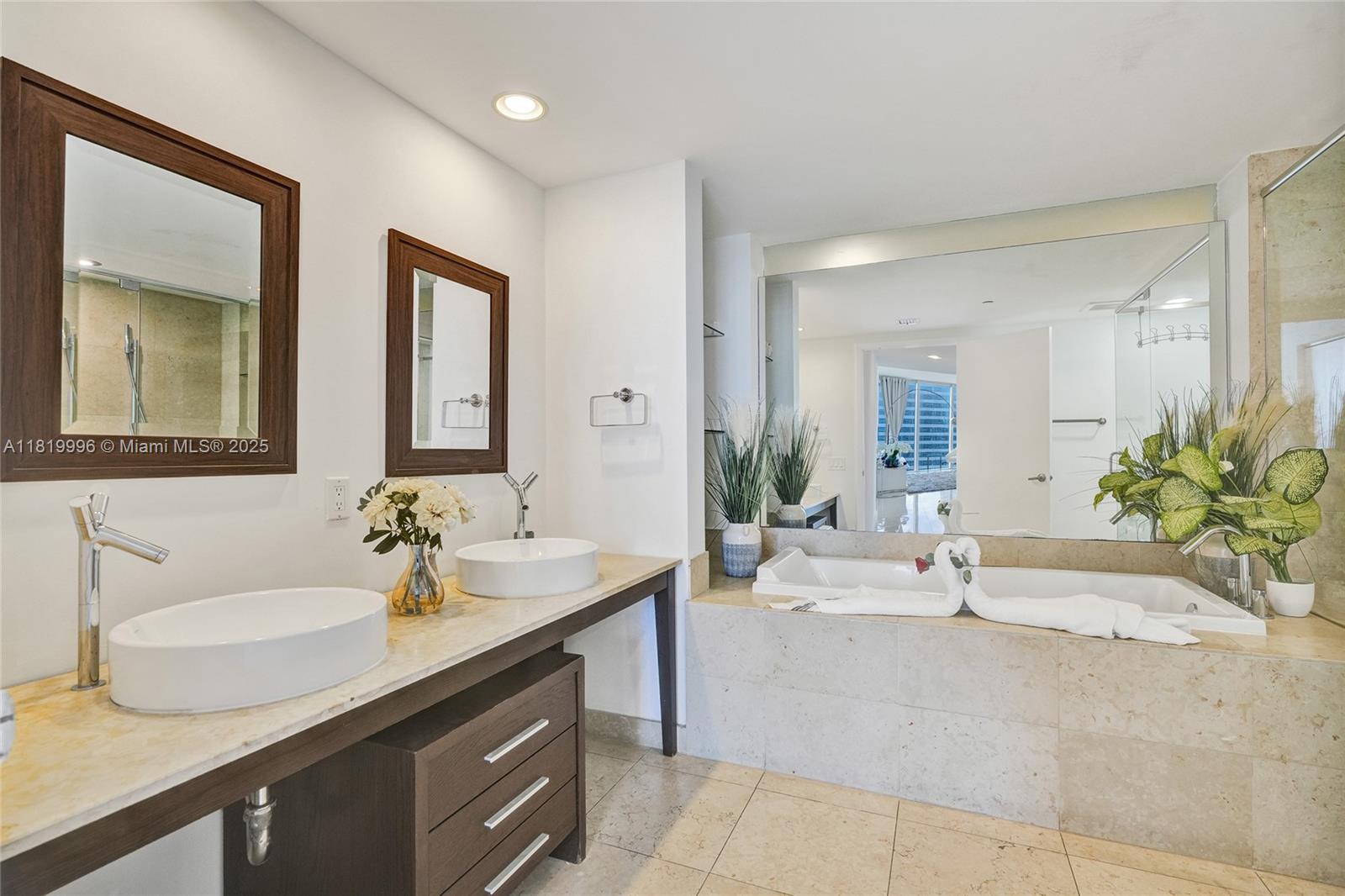 485 Brickell Avenue, Unit 3608 Miami, FL 33131 - Photo 27 of 43 a bathroom with a sink and a mirror