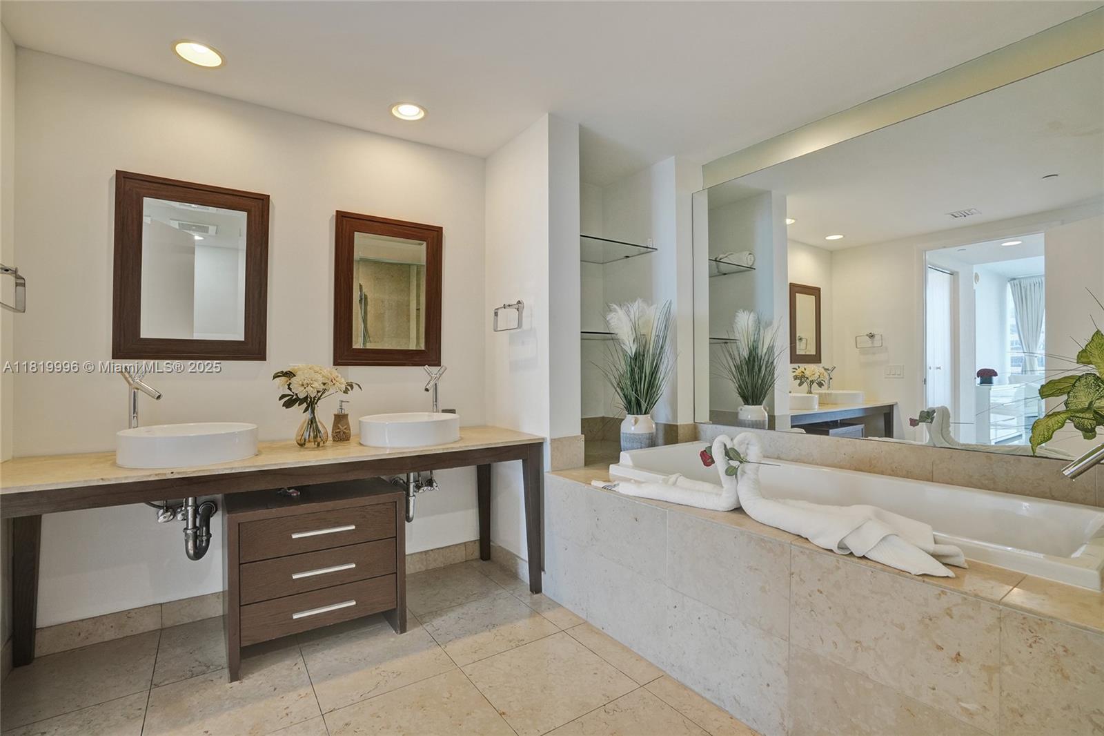 485 Brickell Avenue, Unit 3608 Miami, FL 33131 - Photo 28 of 43 a spacious bathroom with a bathtub a double vanity sink and a mirror