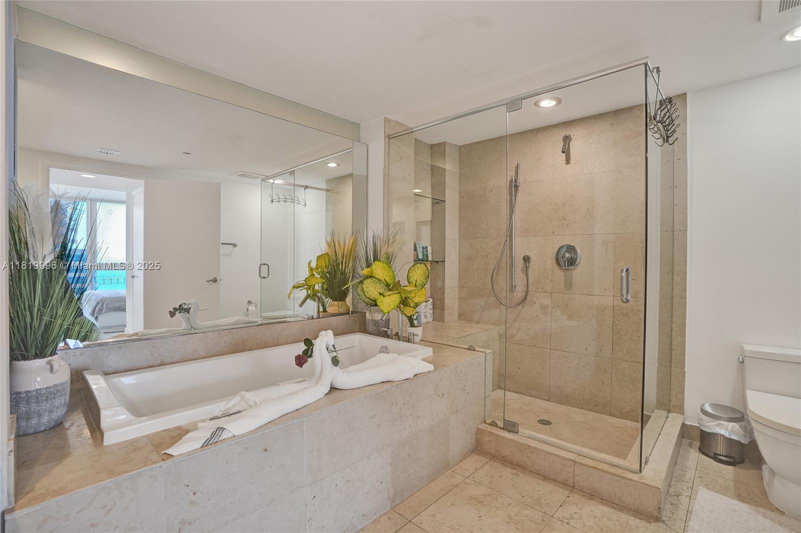 485 Brickell Avenue, Unit 3608 Miami, FL 33131 - Photo 29 of 43 a spacious bathroom with a bathtub shower and a sink