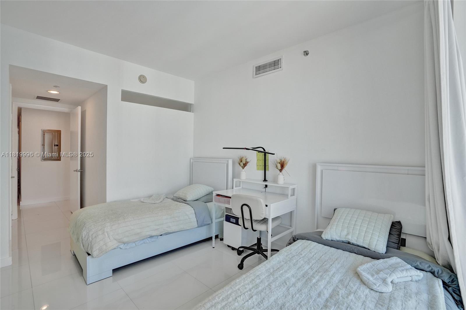 485 Brickell Avenue, Unit 3608 Miami, FL 33131 - Photo 33 of 43 a bedroom with a bed and wooden floor
