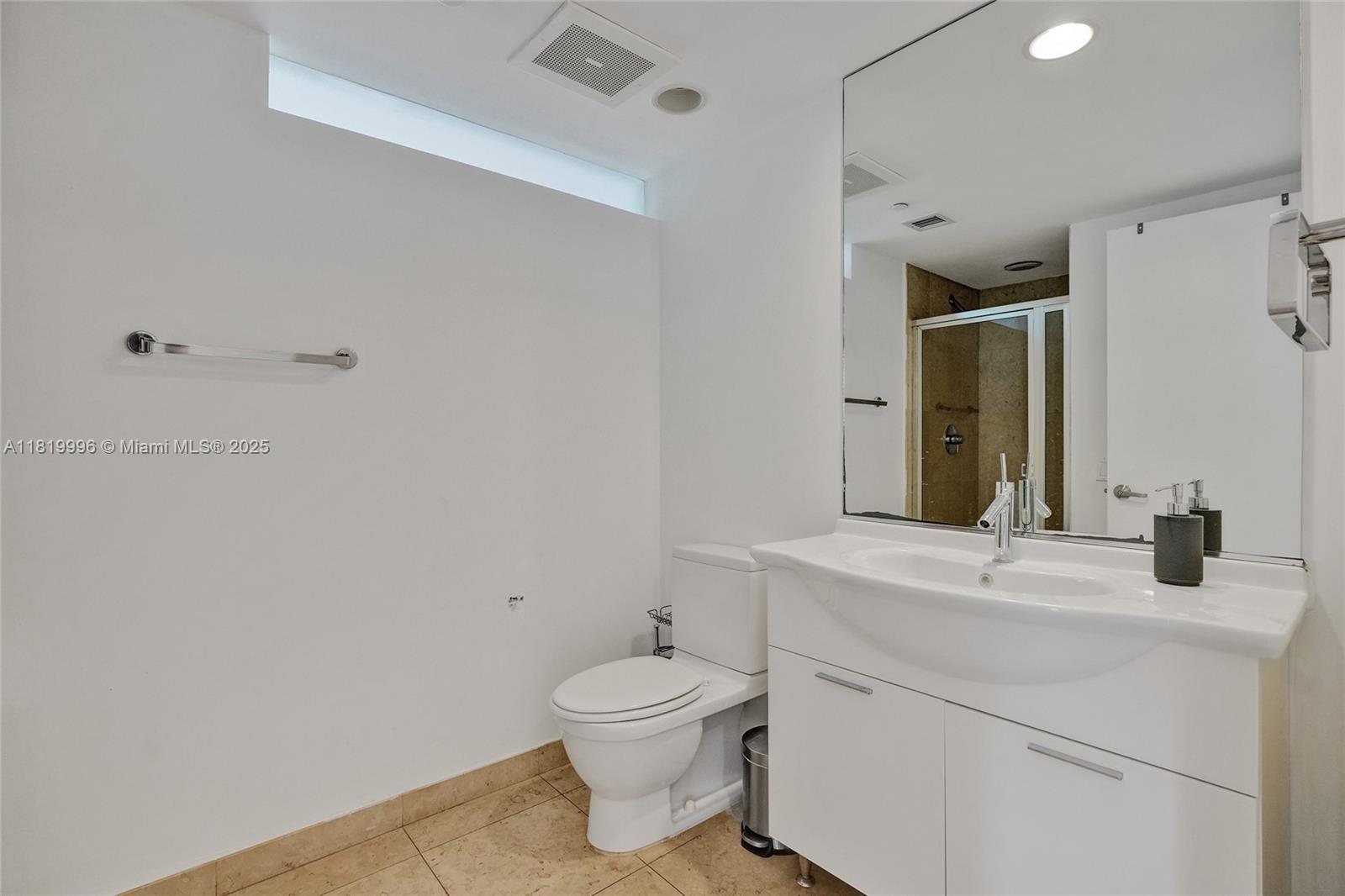 485 Brickell Avenue, Unit 3608 Miami, FL 33131 - Photo 35 of 43 a bathroom with a toilet sink vanity and mirror