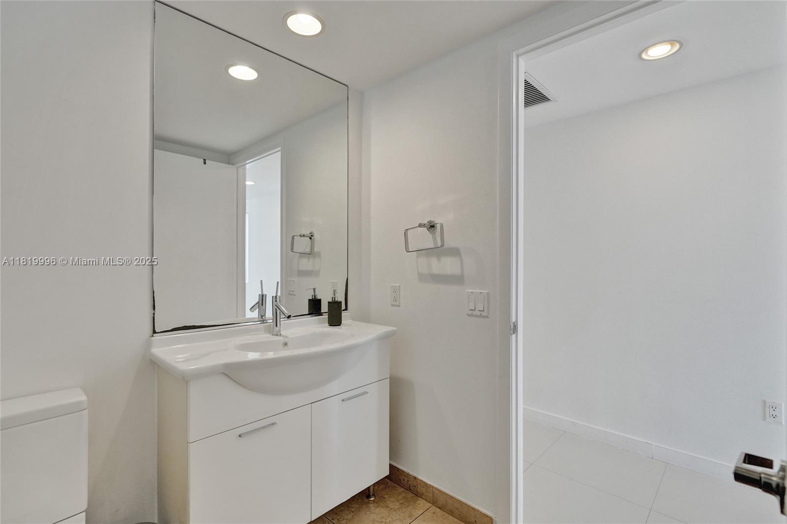 485 Brickell Avenue, Unit 3608 Miami, FL 33131 - Photo 36 of 43 a bathroom with a sink a toilet and a mirror