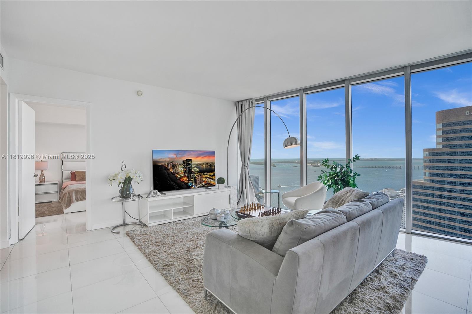 485 Brickell Avenue, Unit 3608 Miami, FL 33131 - Photo 4 of 43 a living room with furniture and a flat screen tv
