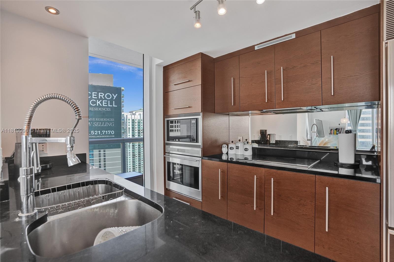 485 Brickell Avenue, Unit 3608 Miami, FL 33131 - Photo 7 of 43 a kitchen with stainless steel appliances granite countertop a sink a stove and a refrigerator