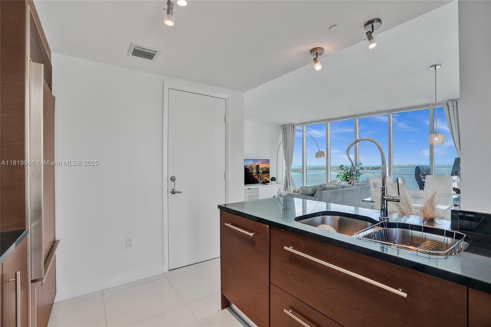 485 Brickell Avenue, Unit 3608 Miami, FL 33131 - Photo 9 of 43 a kitchen with stainless steel appliances granite countertop a sink and a granite counter tops with wooden floors