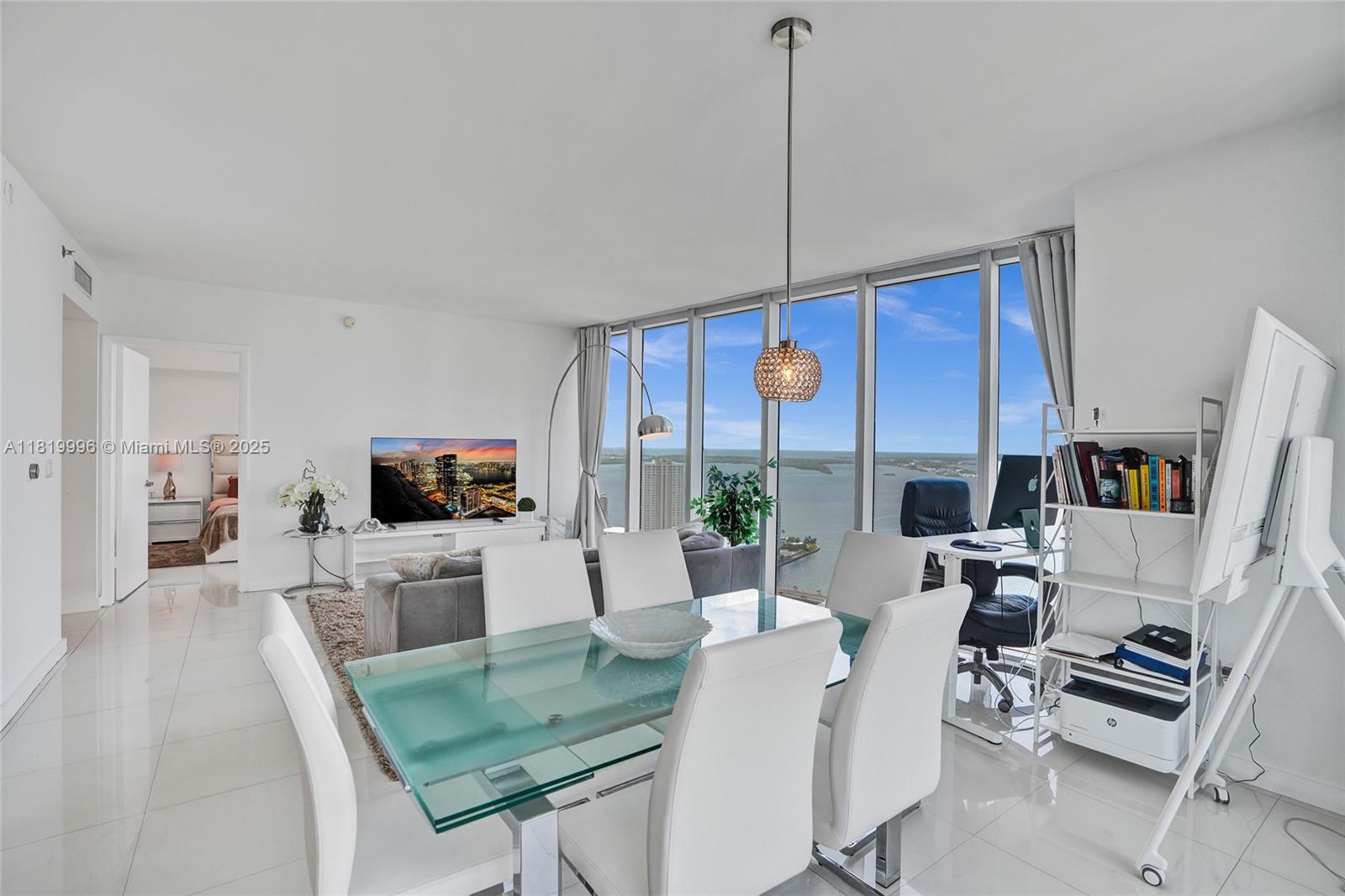 485 Brickell Avenue, Unit 3608 Miami, FL 33131 - Photo 10 of 43 a living room with furniture a flat screen tv and a large window