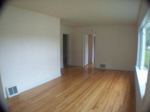 1339 183rd Street Homewood, IL 60430 - Photo 14 of 16 an empty room with wooden floor and windows