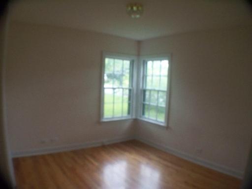 1339 183rd Street Homewood, IL 60430 - Photo 15 of 16 an empty room with wooden floor and windows