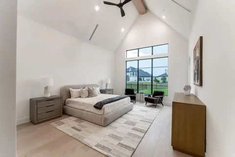 a living room with furniture and large windows
