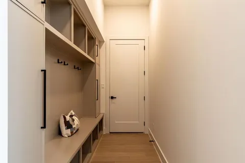 a hallway with white door and stairs