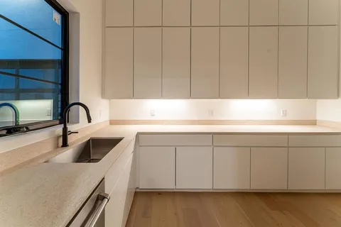 a kitchen with a sink and cabinets