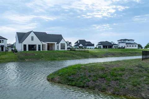 an aerial view of a house with outdoor space and lake view