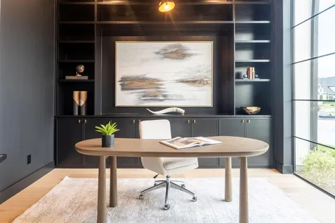 a view of a dining room with a table and chairs
