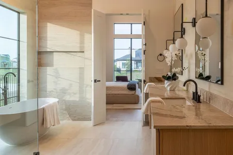 a bathroom with a tub sink and mirror
