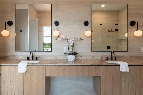 a bathroom with a double vanity sink and mirror