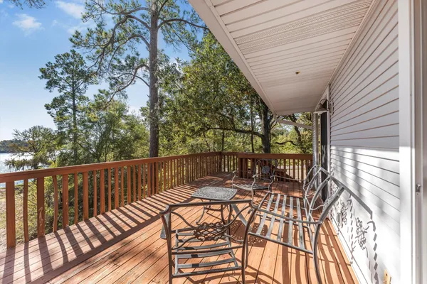a view of balcony with wooden floor and outdoor seating