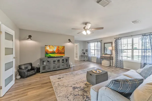 a living room with furniture and a flat screen tv