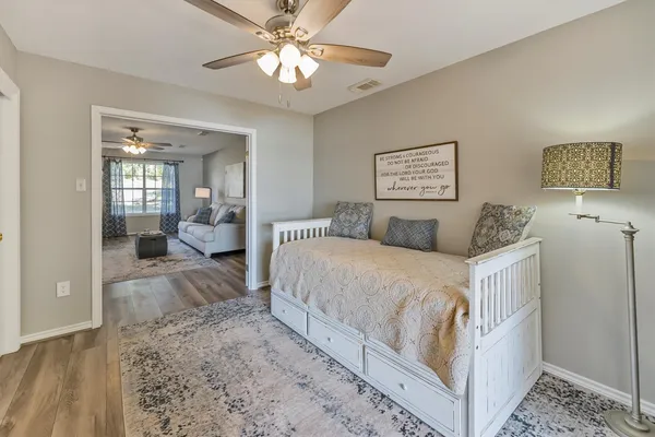 a spacious bedroom with a bed and a walk in closet