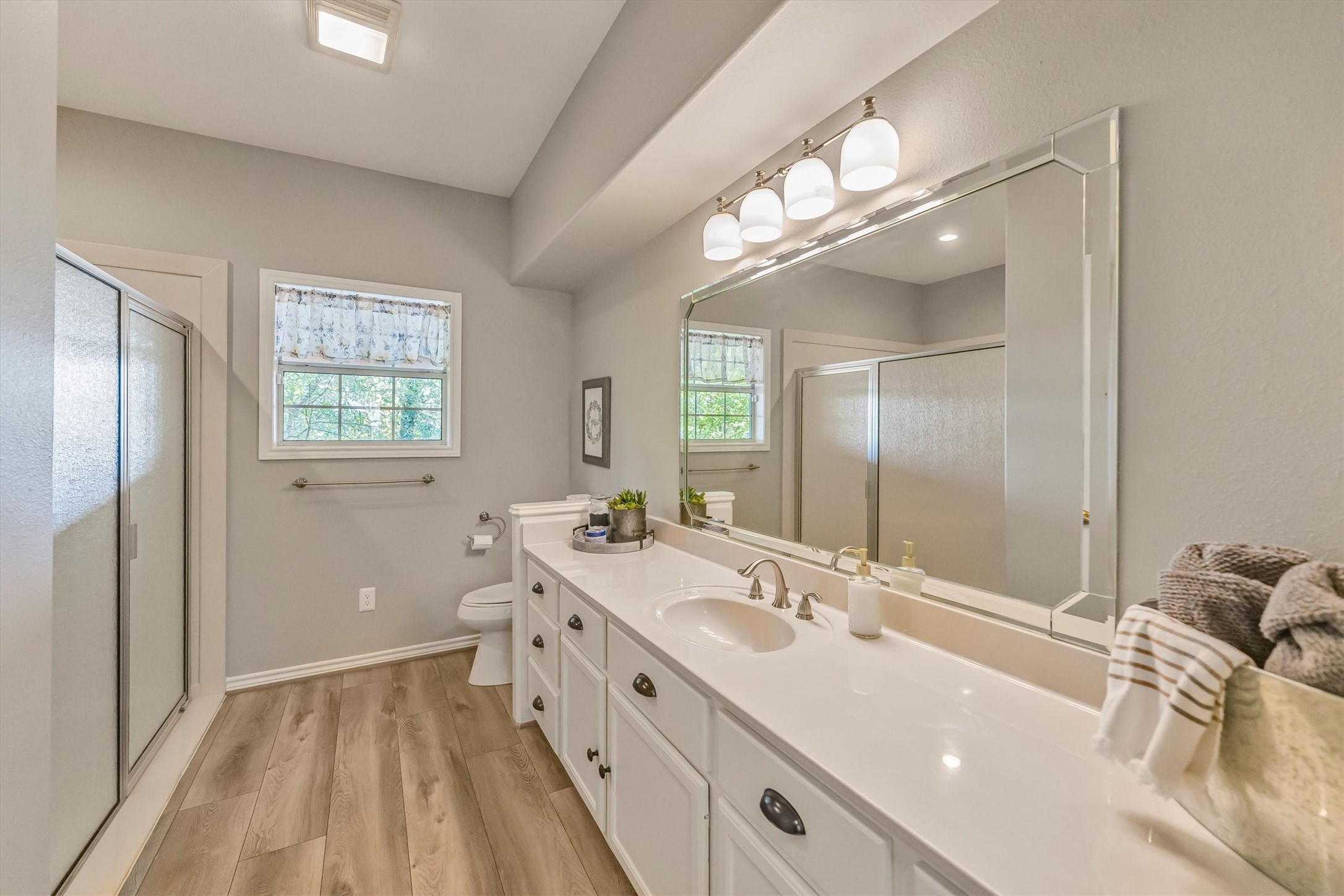 123 Palisade Circle Huntsville, TX 77320 - Photo 21 of 50 a bathroom with a double vanity sink and mirror with shower