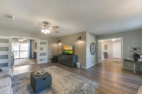 a living room with furniture and wooden floor