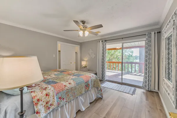 a bedroom with a large bed and a large window with outer view