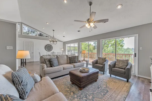 a living room with furniture ceiling fan and a rug