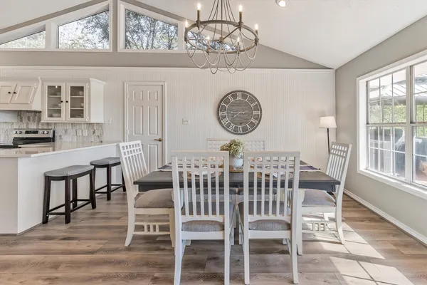 a view of a dining room with furniture window and wooden floor