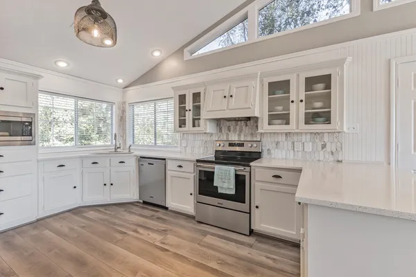 a kitchen with stainless steel appliances granite countertop a stove and a sink