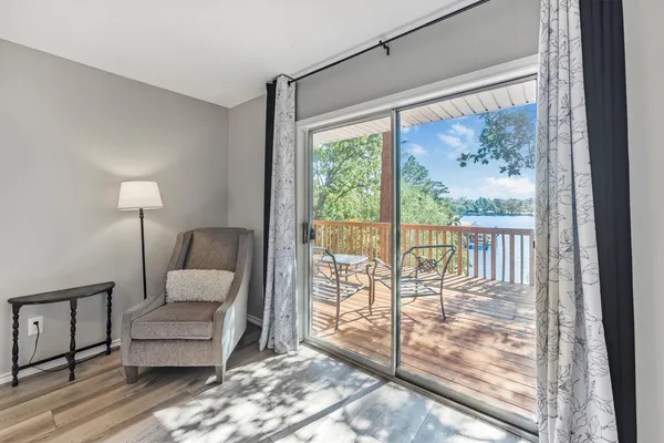 a bedroom with a balcony a bed and a large window with outer view