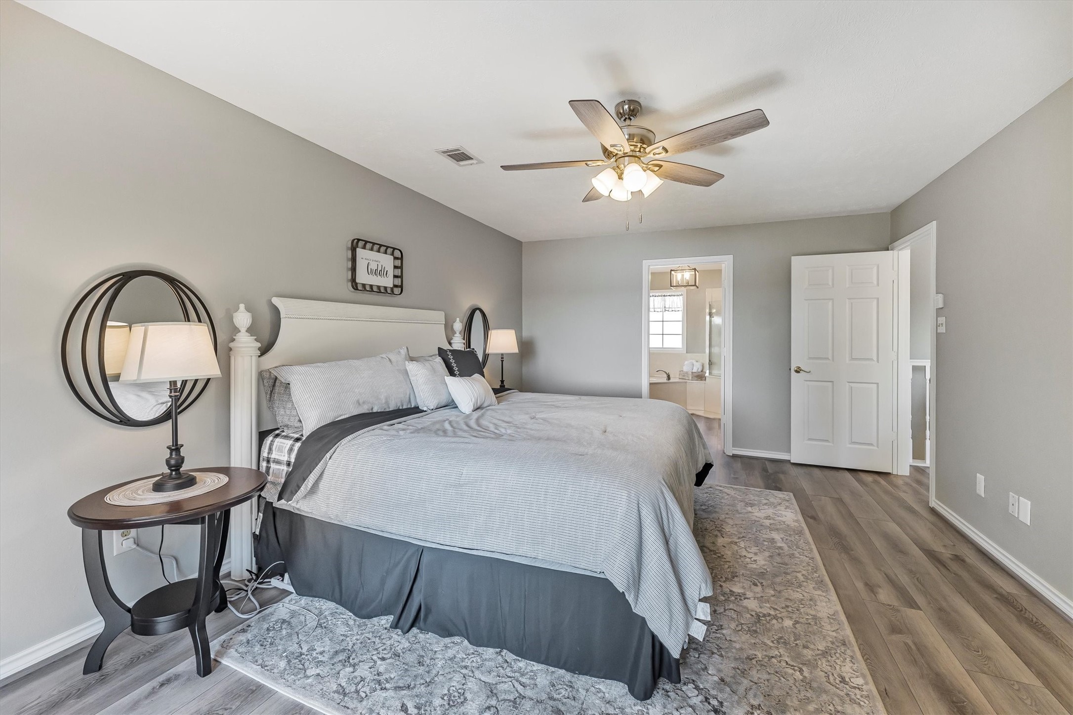 123 Palisade Circle Huntsville, TX 77320 - Photo 46 of 50 a bedroom with a bed and a chandelier