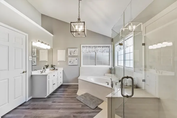 a kitchen with stainless steel appliances granite countertop a stove a refrigerator and a dining table with wooden floor