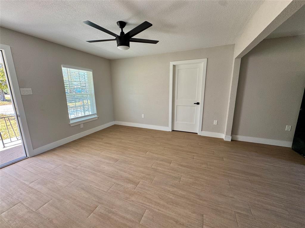 3824 Patman Street Lancaster, TX 75134 - Photo 14 of 24 wooden floor in an empty room with a window