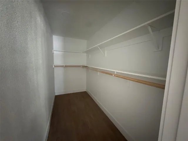 a bathroom with a double vanity sink toilet and shower