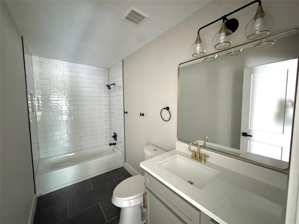 3824 Patman Street Lancaster, TX 75134 - Photo 23 of 24 a bathroom with a sink a toilet and shower