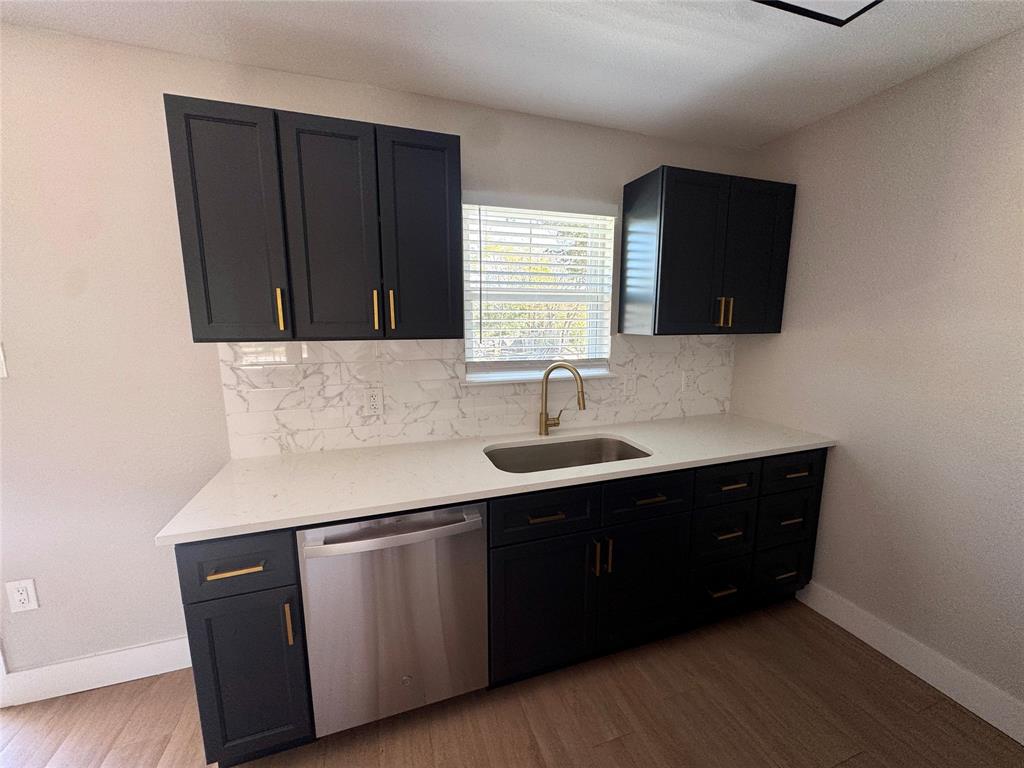 3824 Patman Street Lancaster, TX 75134 - Photo 8 of 24 a kitchen with a sink and a mirror