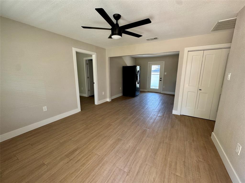 3824 Patman Street Lancaster, TX 75134 - Photo 10 of 24 wooden floor in an empty room with a window