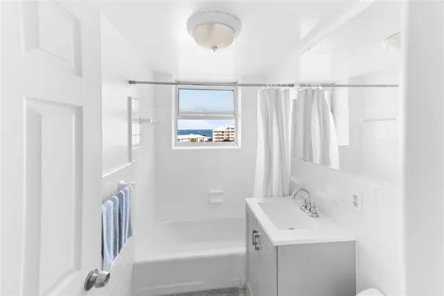 a bedroom with a large bed and ceiling fan