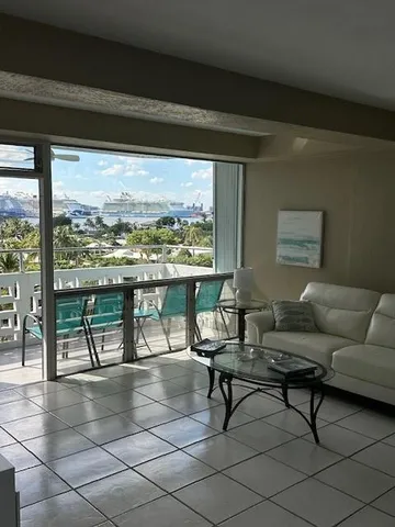 a living room with furniture and a floor to ceiling window