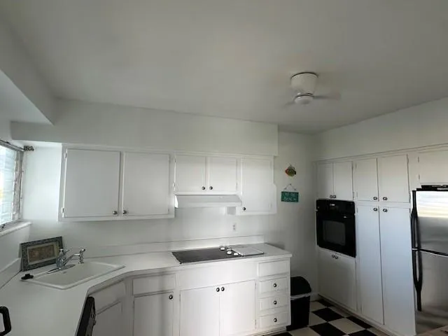 a kitchen with a sink appliances and cabinets