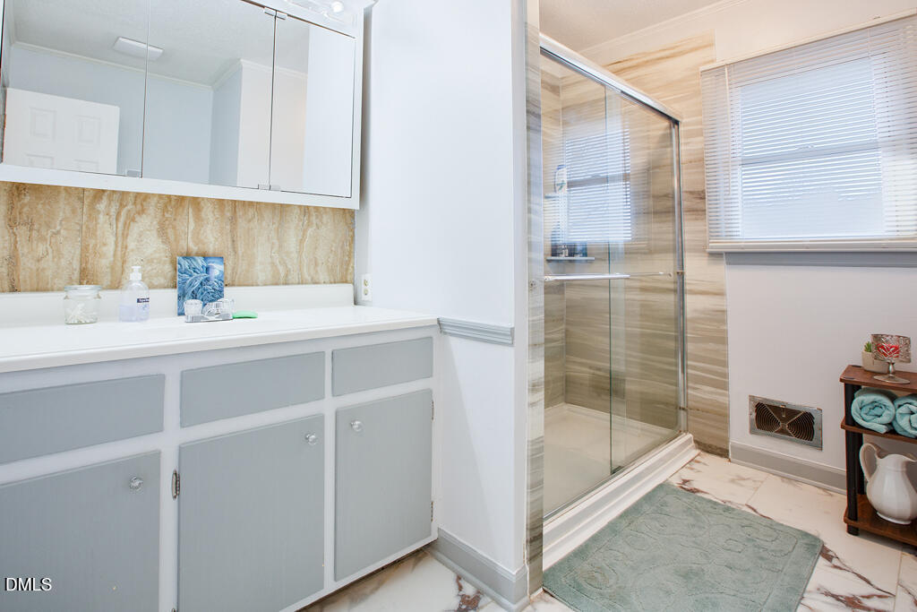 1727 Pinecrest Road Henderson, NC 27536 - Photo 10 of 14 a bathroom with a sink and a shower