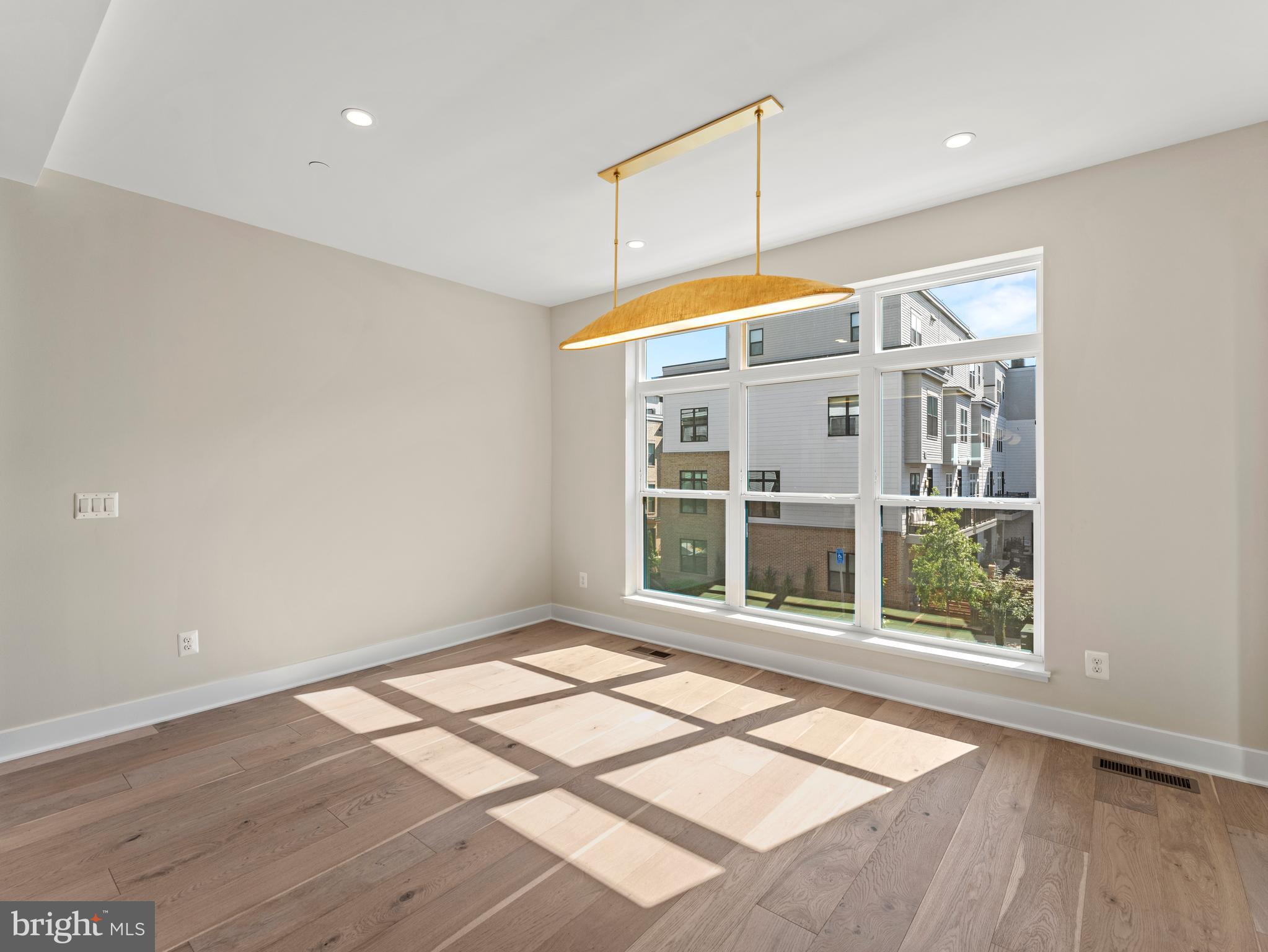 2015 Tysons Ridgeline Road Falls Church, VA 22043 - Photo 15 of 33 an empty room with wooden floor and windows
