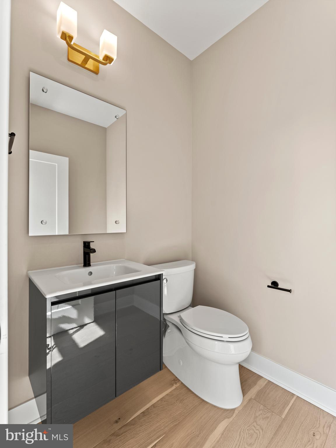 2015 Tysons Ridgeline Road Falls Church, VA 22043 - Photo 16 of 33 a bathroom with a toilet sink vanity and mirror
