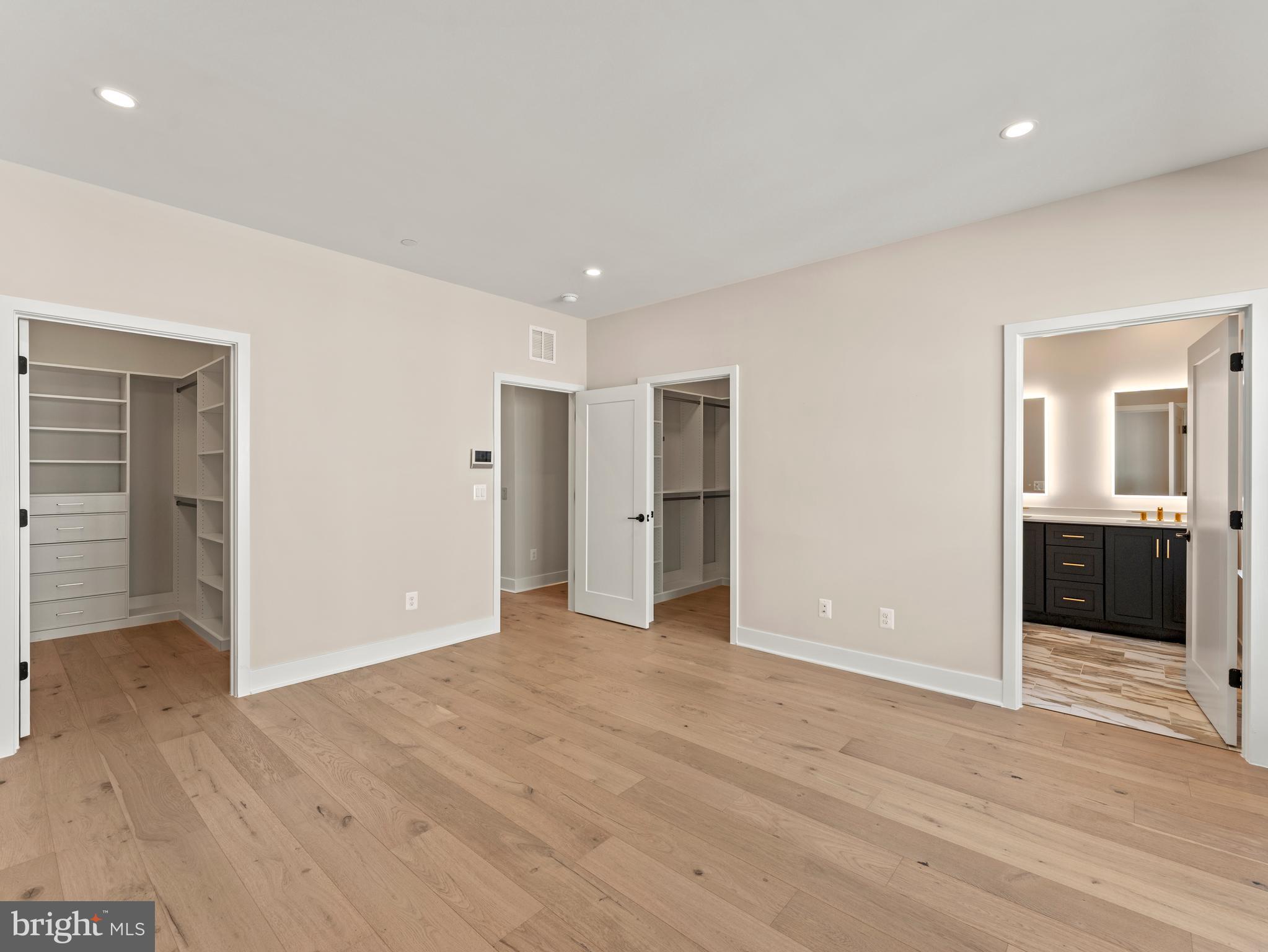2015 Tysons Ridgeline Road Falls Church, VA 22043 - Photo 18 of 33 an empty room with wooden floor and bathroom