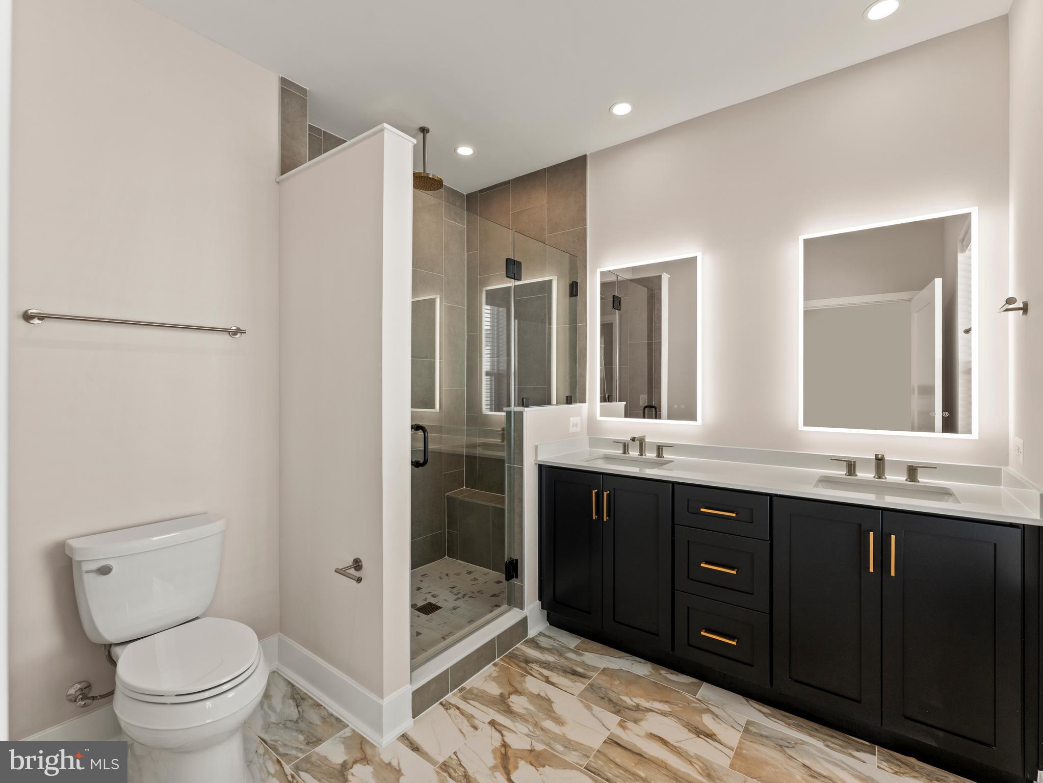 2015 Tysons Ridgeline Road Falls Church, VA 22043 - Photo 19 of 33 a bathroom with a granite countertop sink toilet and shower
