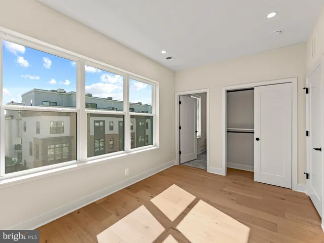 a bathroom with a granite countertop sink a toilet a mirror and shower