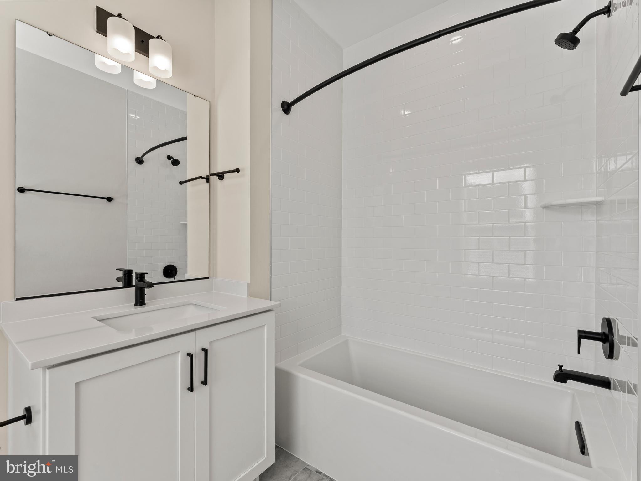 2015 Tysons Ridgeline Road Falls Church, VA 22043 - Photo 25 of 33 a bathroom with a granite countertop sink a toilet a mirror and shower