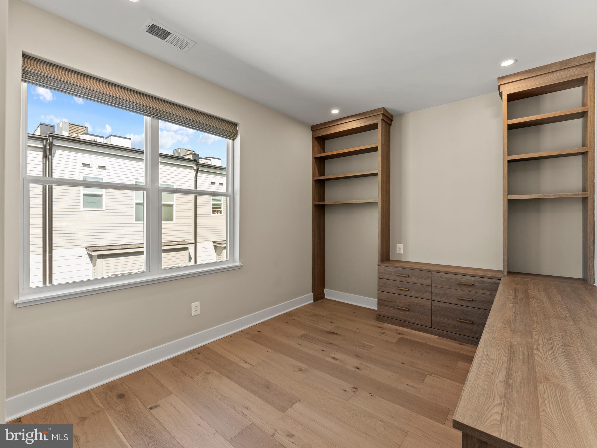 2015 Tysons Ridgeline Road Falls Church, VA 22043 - Photo 28 of 33 a view of an empty room with a window and wooden floor