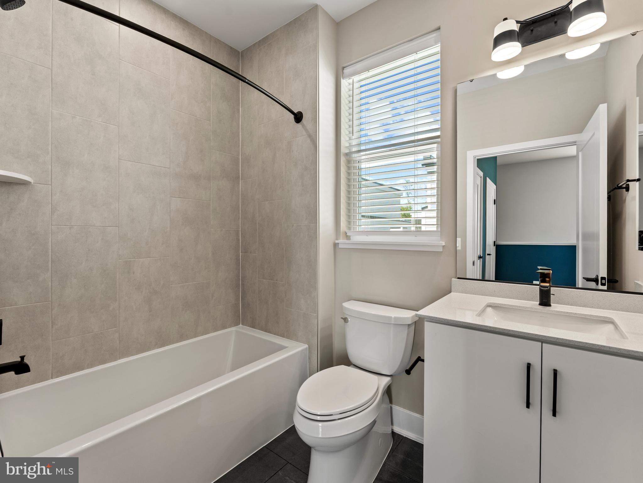 2015 Tysons Ridgeline Road Falls Church, VA 22043 - Photo 29 of 33 a bathroom with a sink a toilet and a bathtub