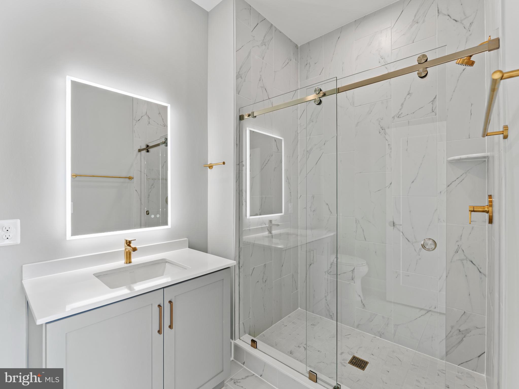 2015 Tysons Ridgeline Road Falls Church, VA 22043 - Photo 6 of 33 a bathroom with a shower sink and mirror