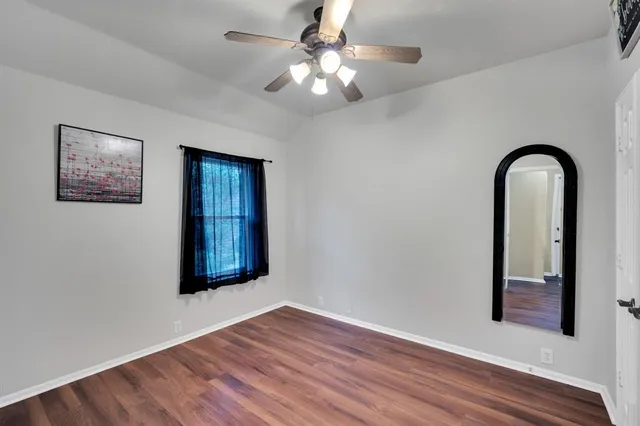 a view of a livingroom with a fireplace wooden floor and window
